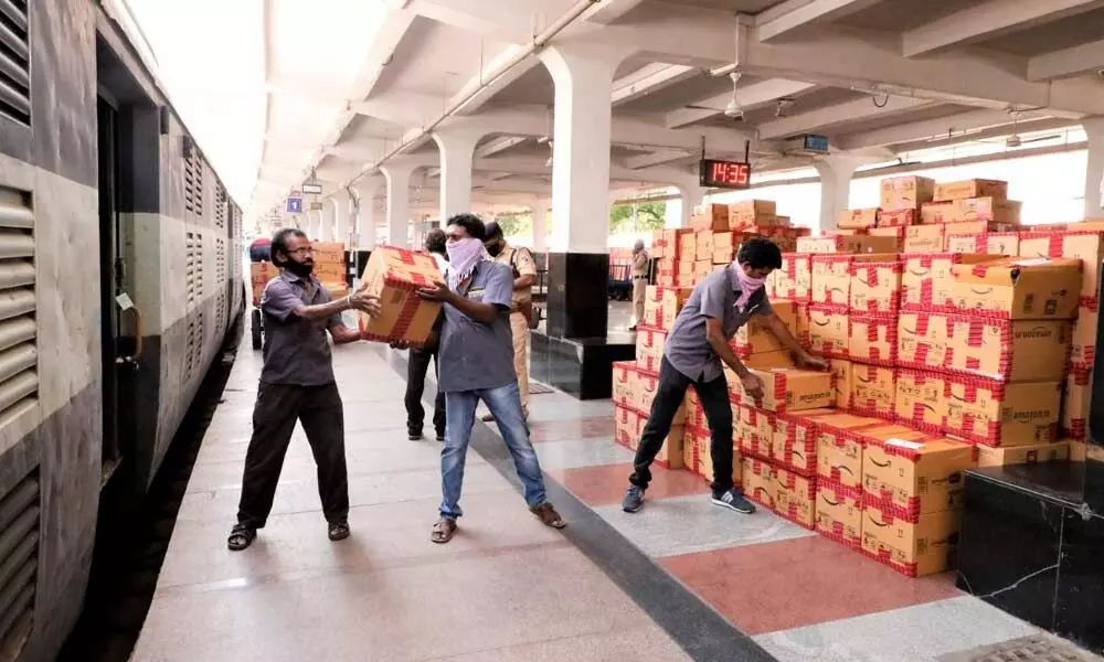 Workers loading parcels into a train