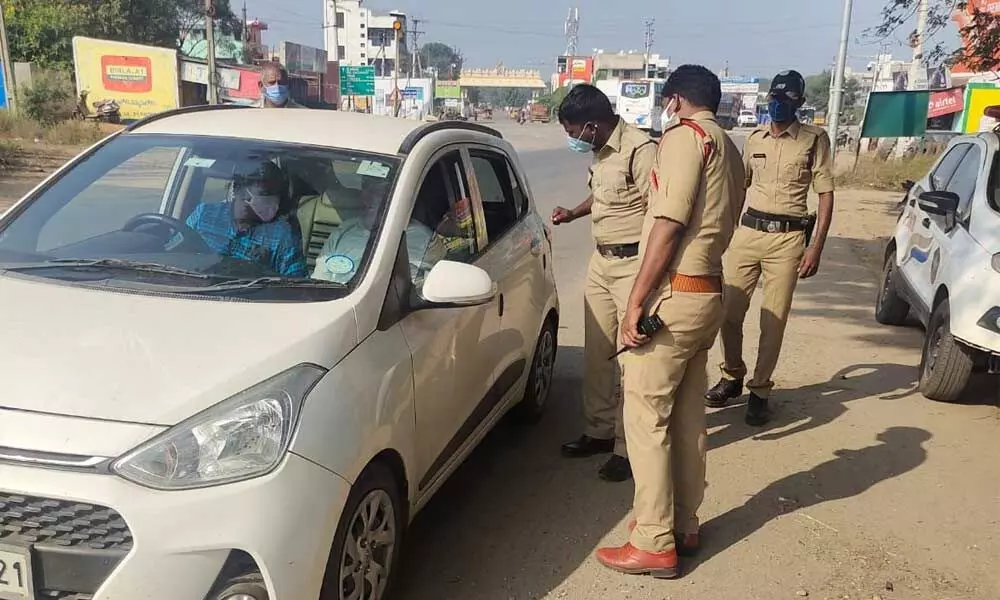 Police conducting vehicle check at Renigunta highway to prevent employees from attending the meeting in Viayawada.