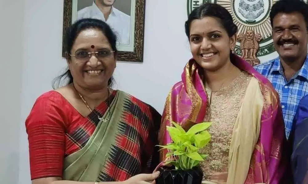 AP State Mahila Commission Chairperson Vasireddy Padma congratulating Bommini Mounika at her office in Mangalagiri on Monday