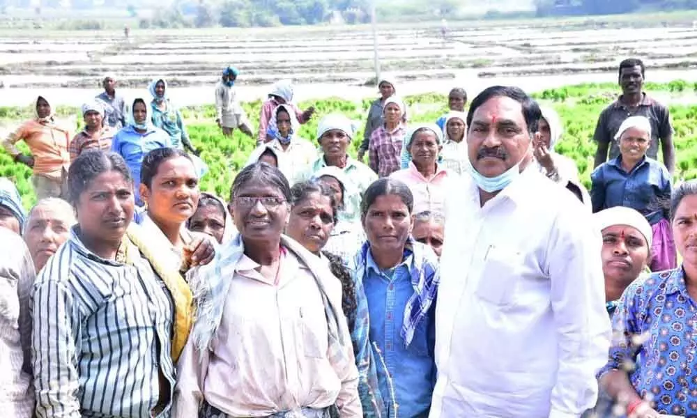 Minister for Panchayat Raj Errabelli Dayakar Rao interacting with farm workers in Kodakandla mandal of Jangaon district on Monday
