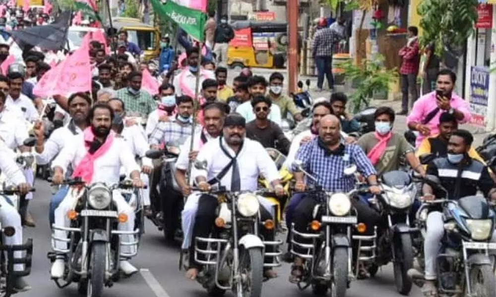 Minister G Kamalakar leading a motor bike rally in Karimnagar on Wednesday