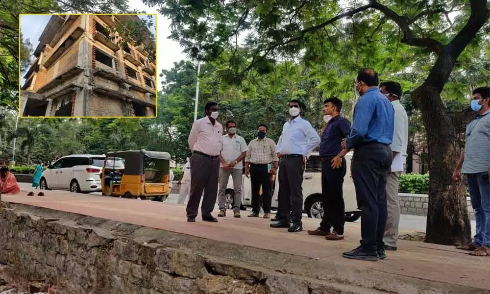 District Collector M Hari Narayanan, Corporation Commissioner P S Girisha and others inspecting APTDC hotel building opposite Ruia hospital in Tirupati on Wednesday