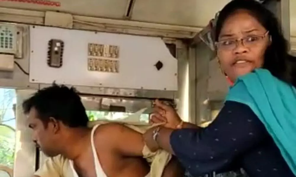 A woman attacking RTC bus driver in Vijayawada on Wednesday