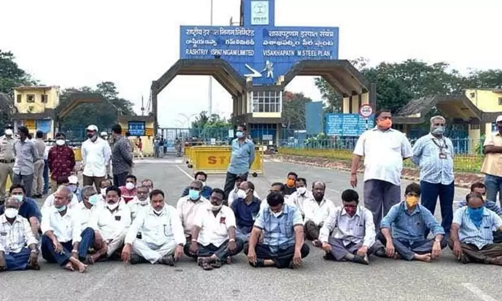 Squatting on the floor, union leaders stage a protest at Kurmannapalem in Visakhapatnam