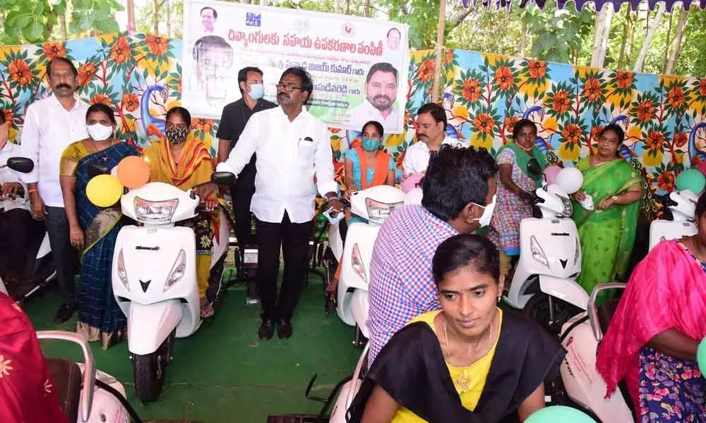 Minister for Transport Puvvada Ajay Kumar distributing battery operated vehicles to PwDs in Khammam on Saturday