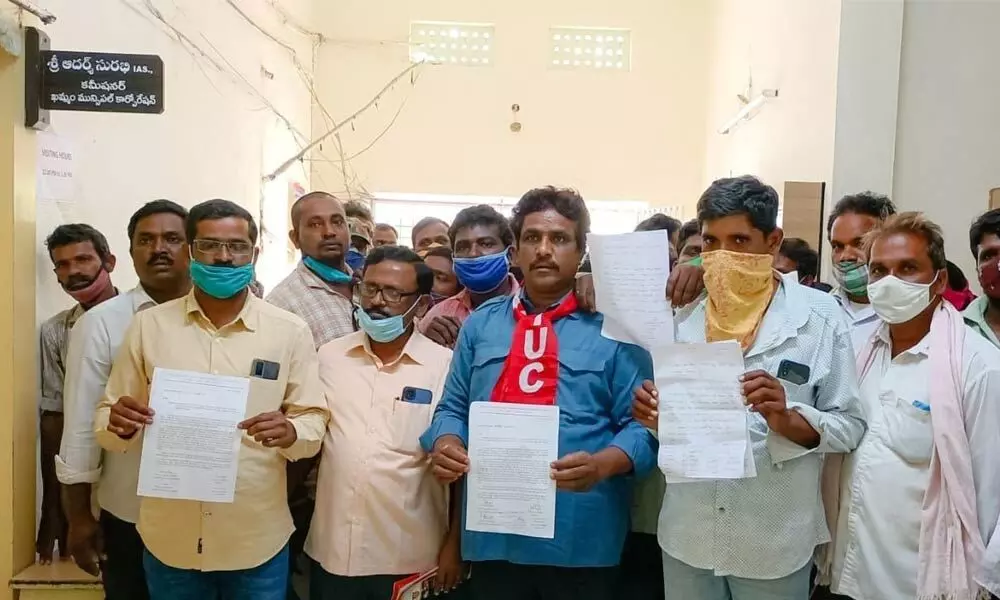 The Municipal workers union leaders submitting a memorandum to the Commissioner of Municipality in Khammam on Monday