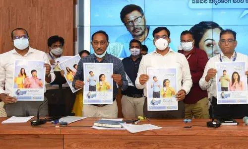 District Collector K V N Chakradhar Babu releasing a poster on banking services at the Collectorate in Nellore on Monday