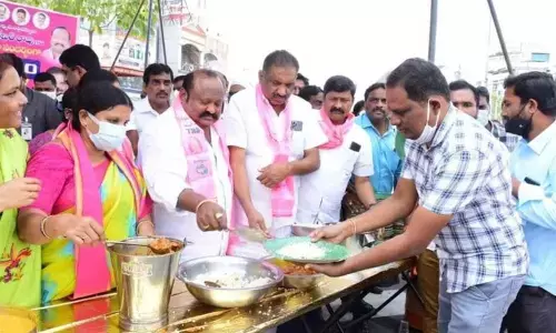 Minister G Kamalakar taking part in Annadanam programme in Karimnagar on Tuesday