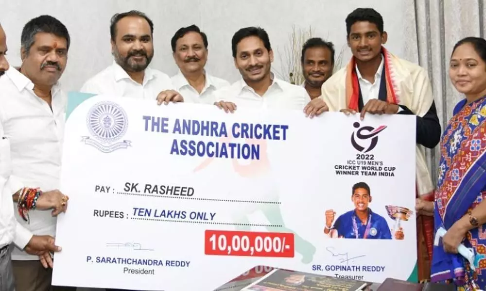 Chief Minister YS Jagan Mohan Reddy presenting a cheque for Rs 10 lakh to cricketer Shaik Rasheed at his camp office in Tadepalli on Wednesday