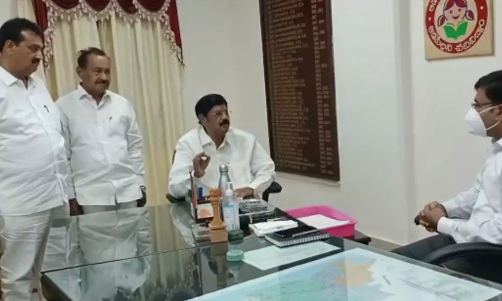 Venkatagiri MLA Anam Ramanarayana Reddy handing over a representation to Collector K V N Chakradhar Babu in Nellore on Wednesday