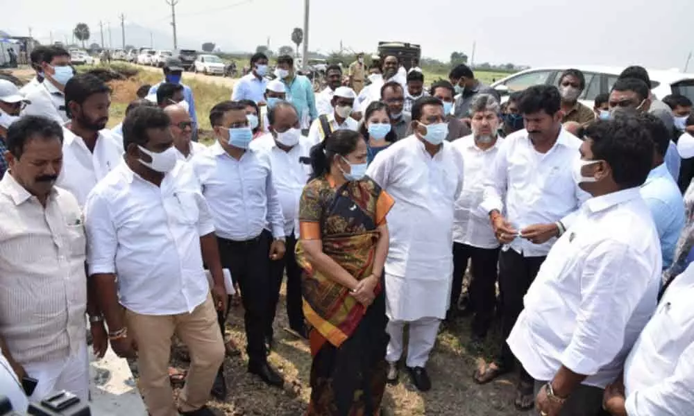 Ministers Ch Sri Ranganadha Raju and M Sucharitha, and District Collector Vivek Yadav reviewing progress of construction of houses at Jagananna Colony at Perecherla on Thursday