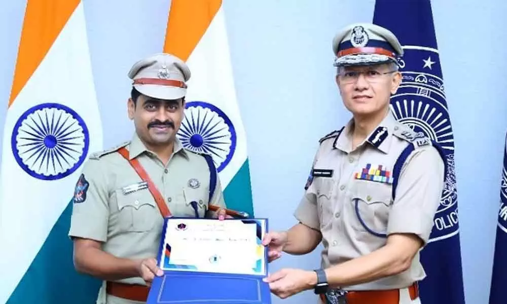 Urban SP Venakata Appala Naidu receiving DGPs Commendation Disc award from DGP Goutham Sawang in Vijayawada on Thursday.