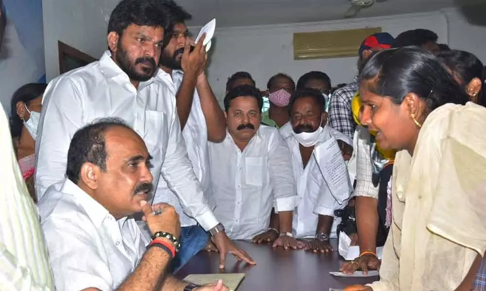 Minister Balineni Srinivasa Reddy receiving urges from public at a  grievance programme at his residence in Ongole on Thursday
