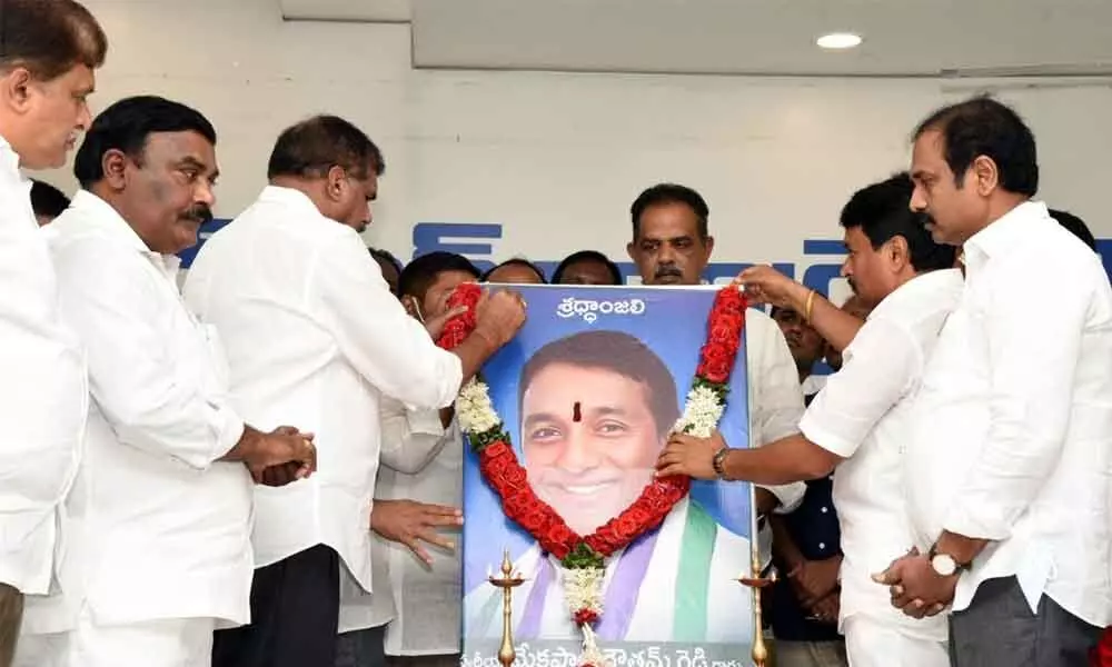 Ministers Botcha Satyanarayana, Vellampalli Srinivas, K Kannababu and other YSRCP leaders paying floral tributes to Industries Minister M Goutham Reddy at the YSRCP central office in Tadepalli on Monday