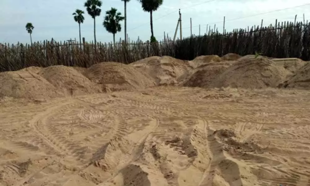 Sea sand stored in an open location at Hukumpeta in  Vajrapukotturu mandal