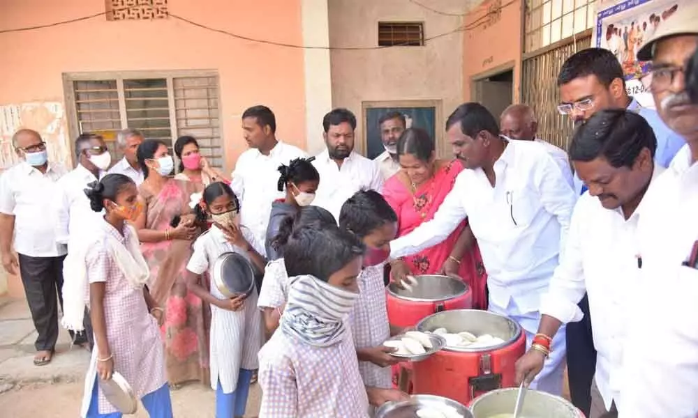 Children being served food provided by centralised kitchen run by Hare Krishna Movement Foundation in Mahbubnagar district