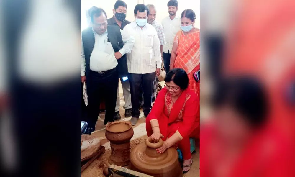 NABARD team member Vandana Sarma making a pot at a pottery unit in Kurabalakota mandal of Madanapalli division in Chittoor district on Tuesday