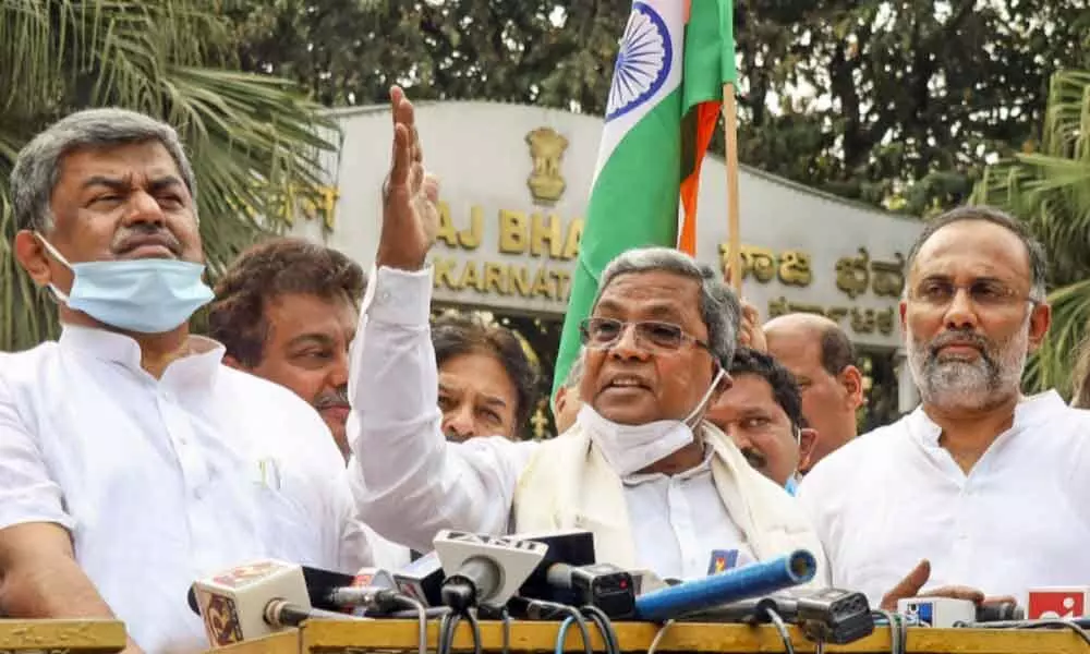 Former chief minister S Siddaramaiah along with other Congress leaders addresses the media after meeting Governor Thawarchand Gehlot seeking immediate action against minister K.S. Eshwarappa for his controversial statement regarding Indian flag, in Bengaluru, Tuesday