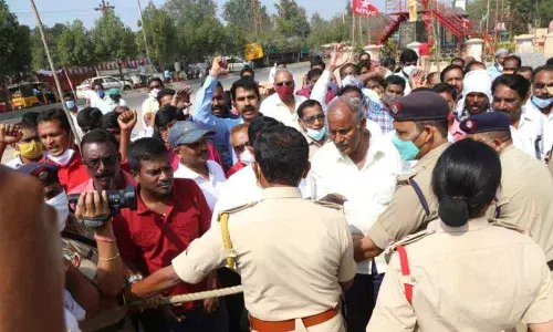 The police and security staff of SCCL stopping former MLA Kunamneni and agitating workers from entering into the SCCL corporate office in Kothagudem on Tuesday