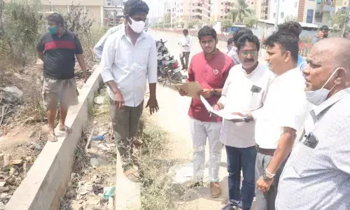 Municipal Commissioner P S Girisha inspecting the road widening works on YSR Marg (DBR Road) along with officials in Tirupati on Wednesday