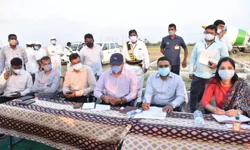 District Collector Vivek Yadav at a review meeting at Perecherla layout on Wednesday. Joint Collectors Anupama Anjali and K Sridhar Reddy, and GMC Commissioner Nishanth Kumar are also seen