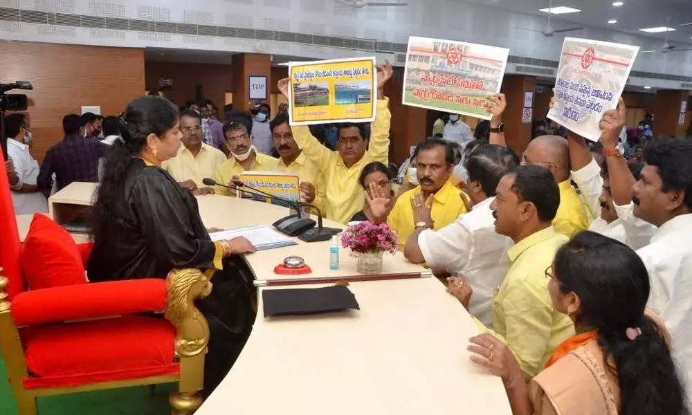 TDP and JSP leaders staging a protest at the podium of Mayor G Hari Venkata Kumari during the GVMC council meeting in Visakhapatnam on Saturday.