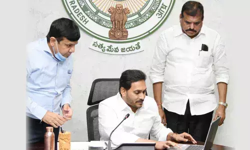 Chief Minister Y S Jagan Mohan Reddy credits the funds under Jagananna Thodu programme into the accounts of beneficiaries at camp office in Tadepalli on Monday
