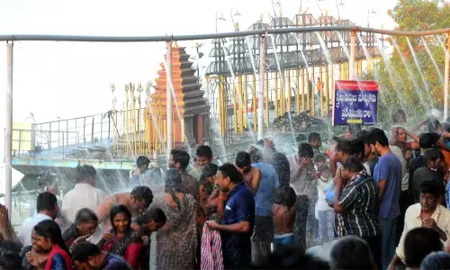 Devotees taking holy bath at Durga ghat near Krishna River in Vijayawada on Tuesday