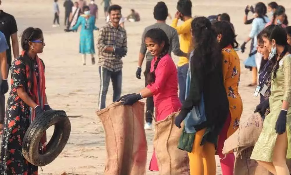 Volunteers and various NGO representatives collecting garbage at beach road on Saturday.