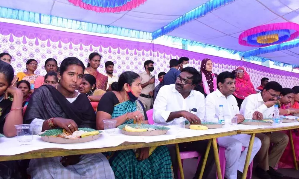 Minister for Transport Puvvada Ajay Kumar participating in mass feeding programme after launching the three-day women’s day celebrations in Khammam on Sunday