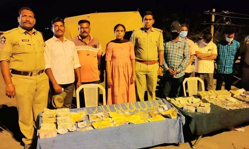 SEB Circle Inspector M Manjula and her staff with seized gold and silver biscuits at Panchalingala border checkpost on Sunday.