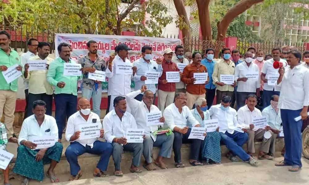 Prawn farmers Prawn farmers staging a protest at district collectorate in Ongole on Monday