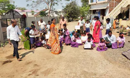 Students of N Bhurjavalasa staging dharna for teacher at the school on Monday
