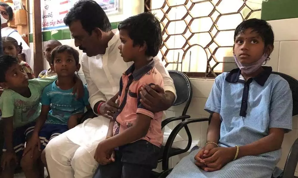 Congress leader G Madhusudhan Reddy interacting with the sick students at a primary healthcare centre on Wednesday