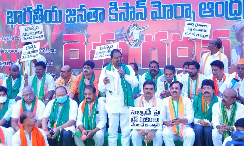 BJP state president Somu Veerraju addressing a Maha Dharna organised to demand clearance of dues to farmers, at agriculture commissioners office in Guntur on Wednesday
