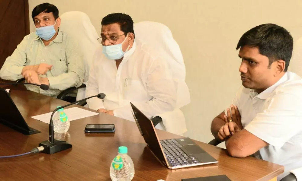 Minister for Housing Ch Sri Ranganadha Raju addressing a meeting at Andhra Pradesh State Housing Corporation office in Vijayawada on Wednesday