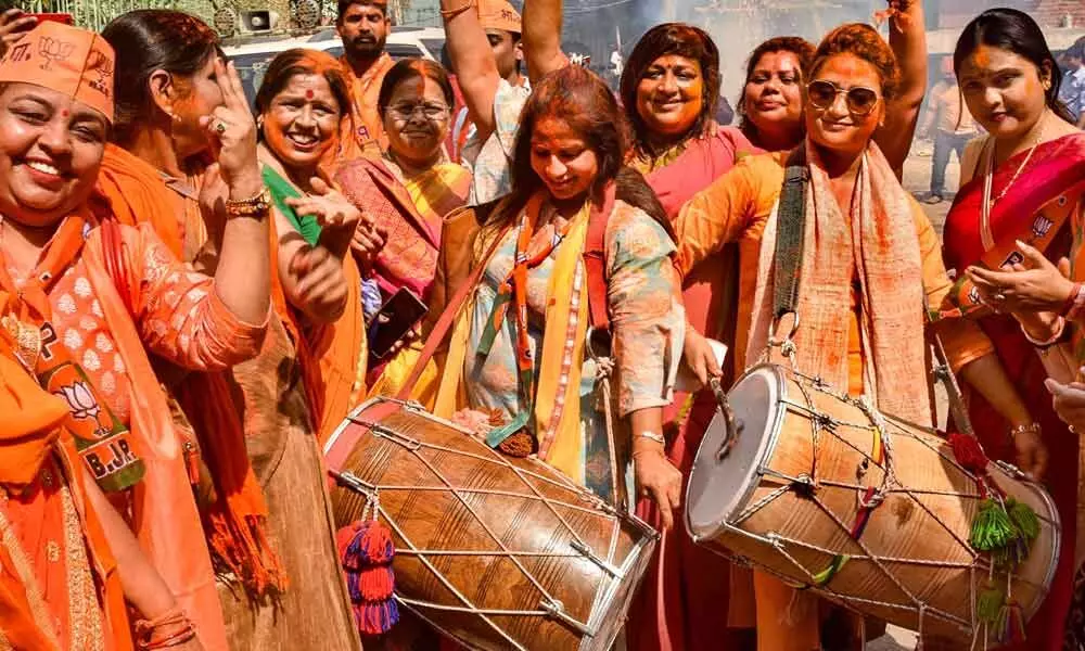 BJP supporters celebrate after partys victory in the Uttar Pradesh Assembly elections, in Varanasi on Thursday