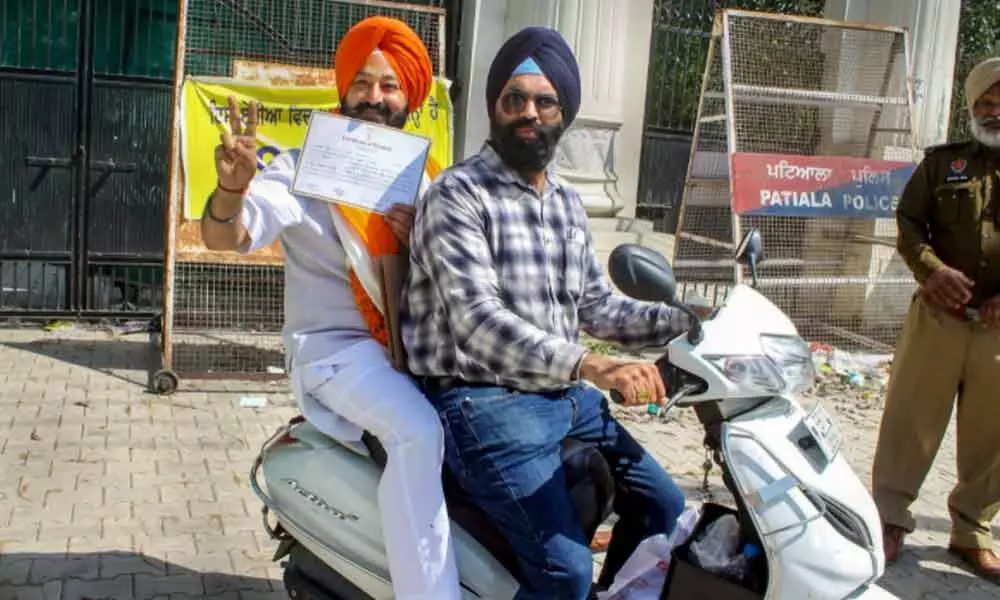 AAP candidate Ajitpal Singh Kohli shows the certificate after winning Patiala urban constituency seat  in Patiala on Thursday