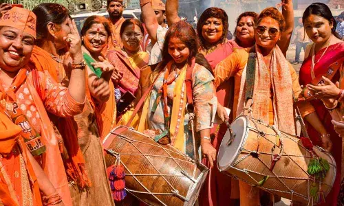 BJP supporters celebrate after partys victory in the Uttar Pradesh Assembly elections, in Varanasi on Thursday