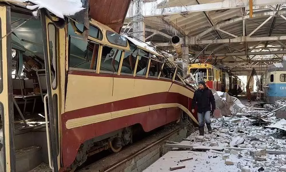 A resident examines a destroyed tram depot in Kharkiv