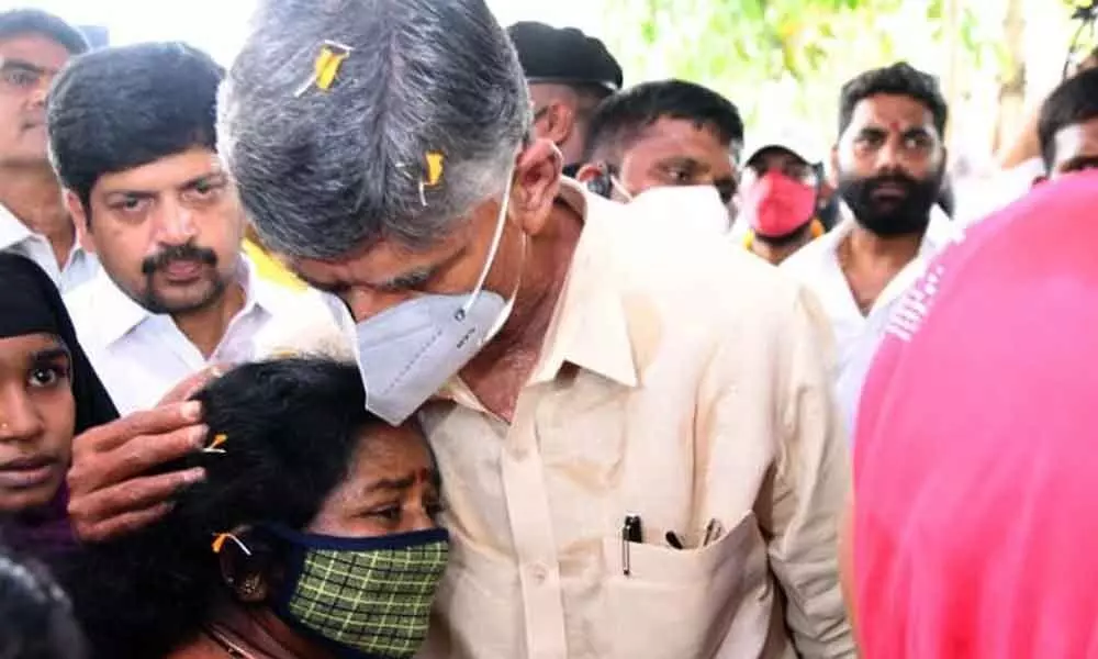 TDP national president N Chandrababu Naidu consoles the family members of a spurious liquor victim in Jangareddygudem on Monday