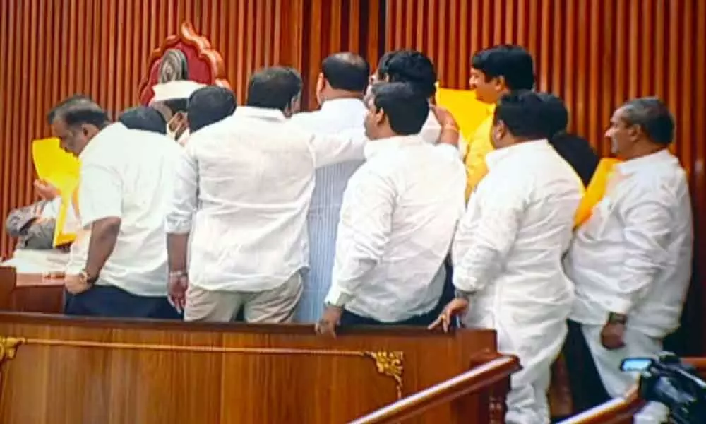 TDP members rush to the Speakers podium continuing high-decibel  slogan-shouting and throw papers at the Chair ignoring his repeated appeals