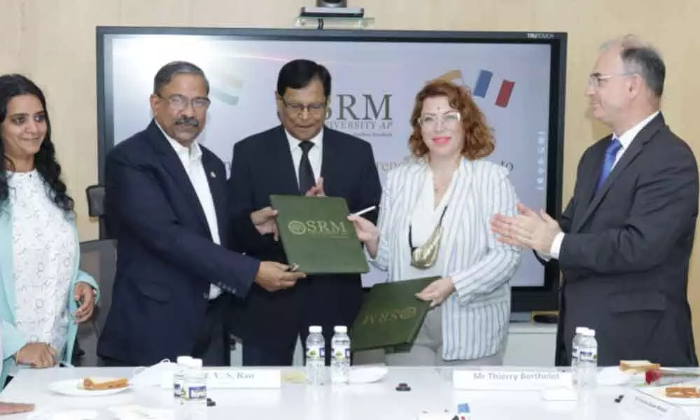 SRM University Vice-Chancellor Prof VS Rao and Rennes School of Business, France, showing the MoU at the varsity in Neerukonda on Monday