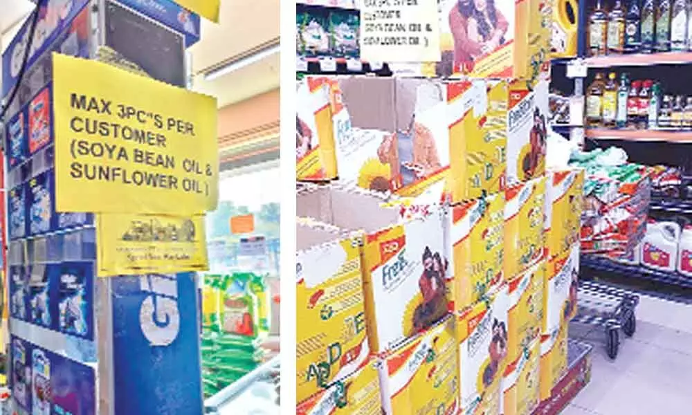 A signboard at an outlet says that each consumer can only buy three packets of oil; The price of the cooking oil was Rs.150 a litre in a store in the first week of March but now it has doubled