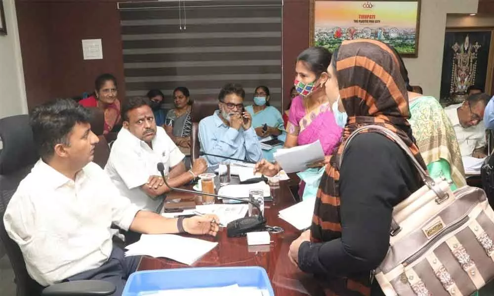 Municipal Commissioner P S Girisha receiving a complaint from a woman during Spandana in Tirupati on Monday