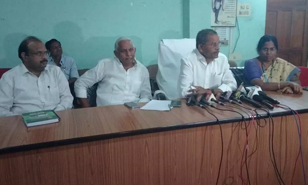 GDCC Bank Chairman R Seetharamanjaneyulu addressing the media in Guntur on Tuesday. Bank CEO Krishnaveni is also seen