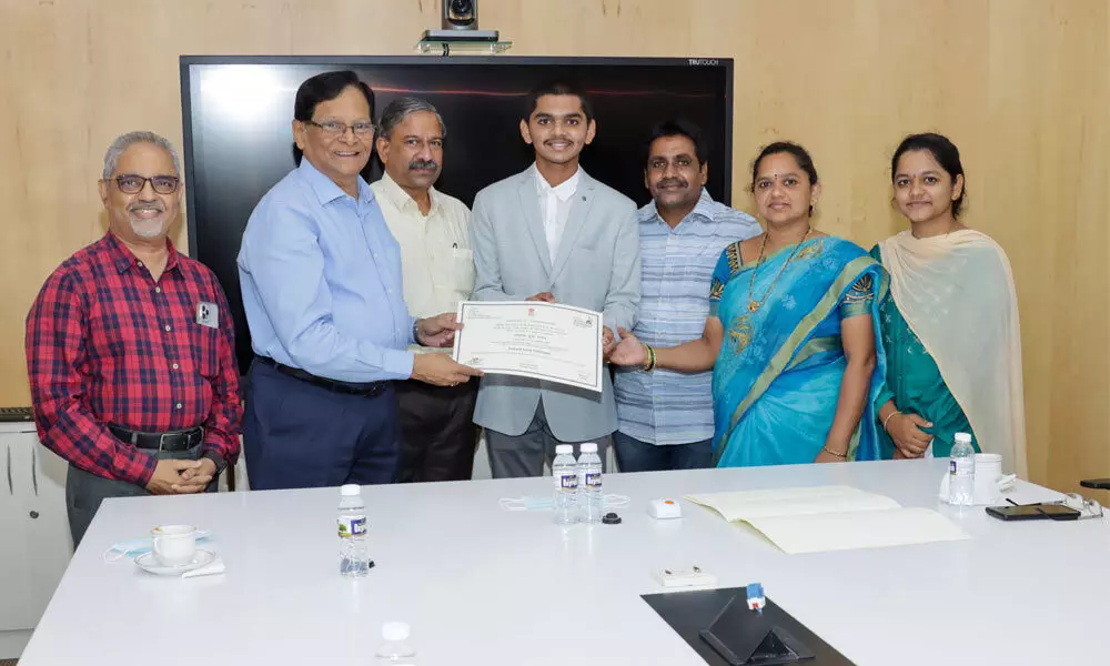 SRM-AP Vice-Chancellor Prof VS Rao and others congratulating first-year B Tech (Computer Science) student Sikindhar Jaladi at the varsity in Neerukonda on Wednesday