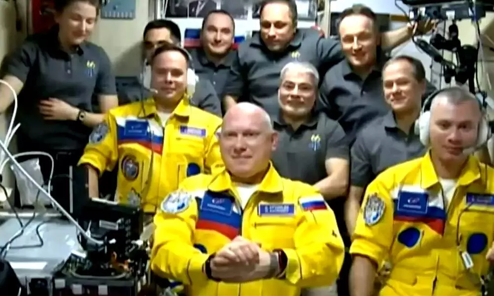 Russian cosmonauts arrive at space station in yellow and blue