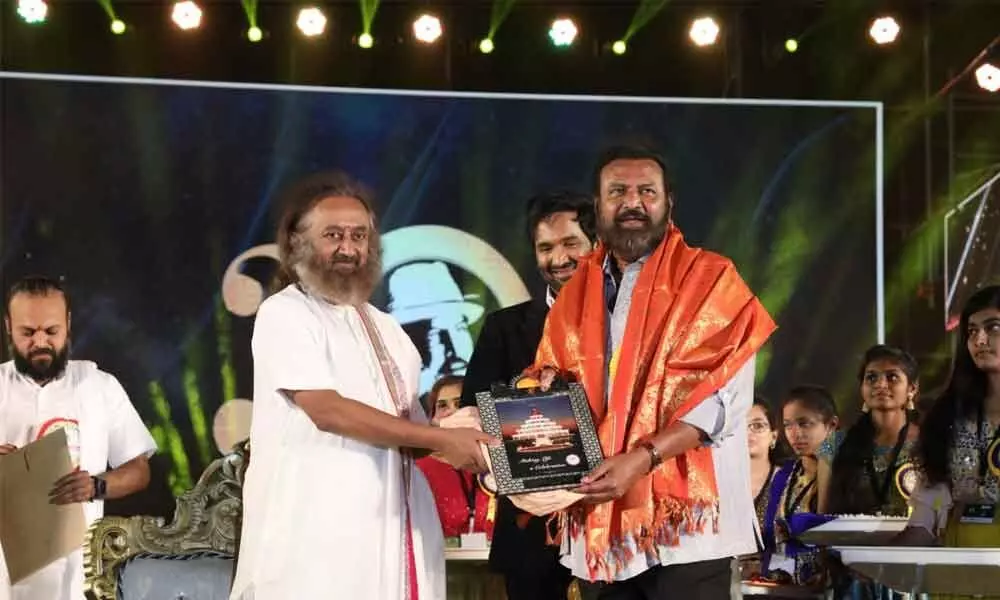 Film actor Mohan Babu felicitating Sri Sri Ravishankar of Art of Living during inauguration of the MBU and the 30th annual day celebrations of Sree Vidyanikethan Educational Institutions at its campus in Rangampally near Tirupati on Saturday