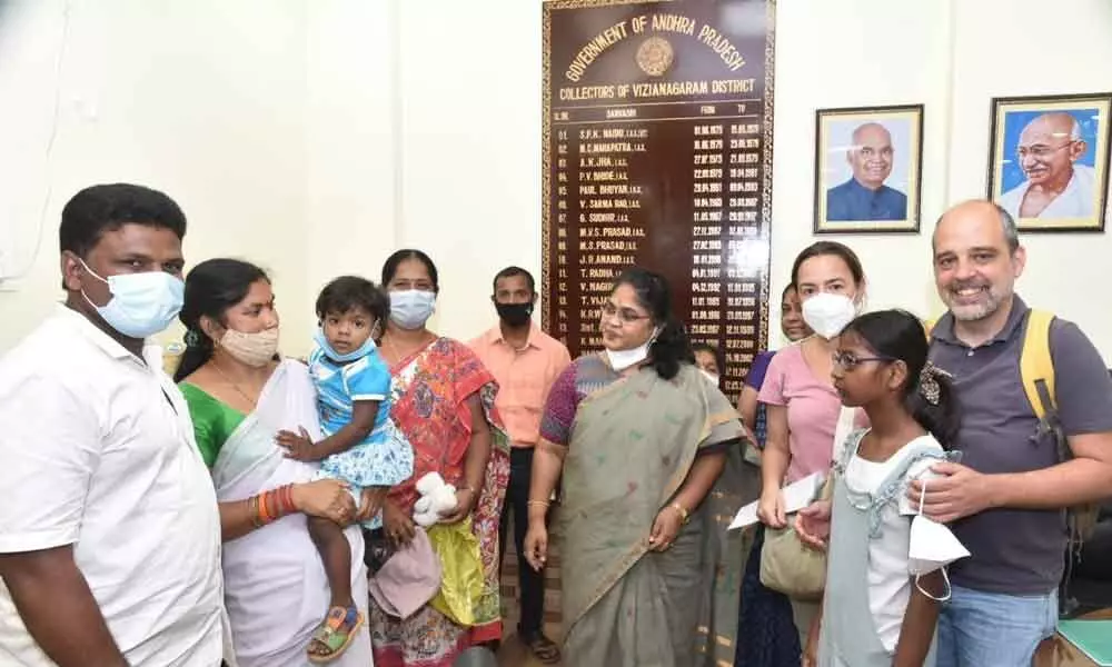 District collector A Surya Kumari handing over the girlchild to Spanish couple